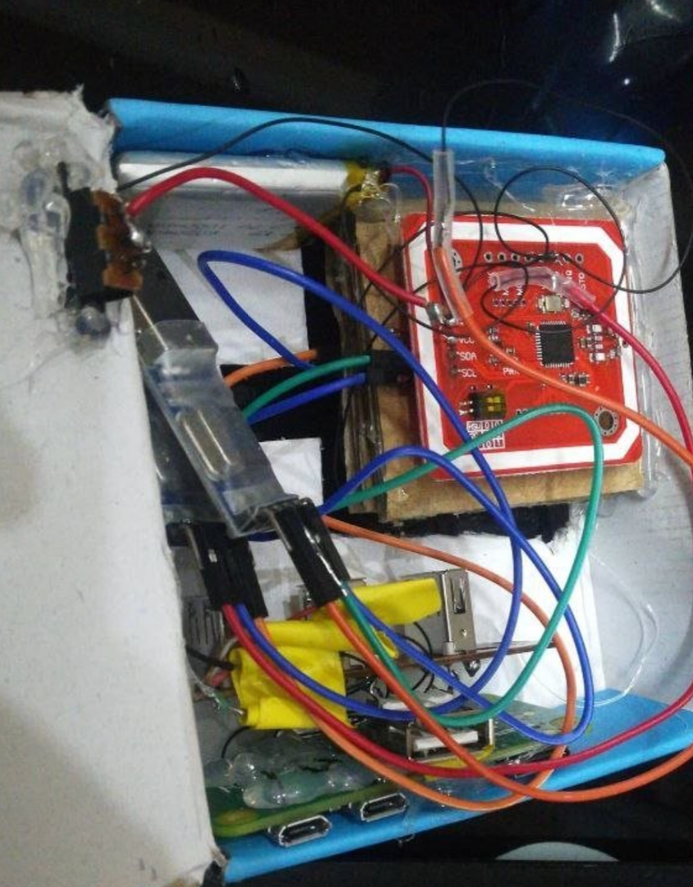 The relay rig — RPi Zero W, 2 PN532s, hotglue and cardboard